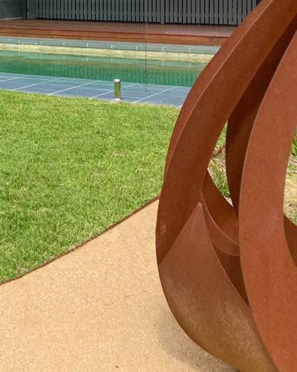 Corten Steel edging on Empire Zoysia Turf next to fire pit and pool