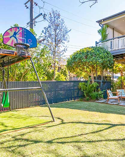 Natural turf lawn with synthetic under play equipment