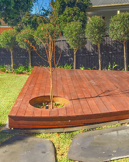 Platform deck with round feature tree detail spilling out towards firepit