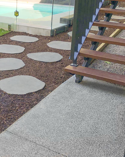 Concreting at base of timber stairs connecting to steppers to pool area